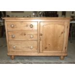 A stripped pine sideboard, the rectangular top above three side drawers and a cupboard door, 122cm