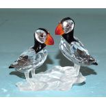 A Swarovski glass group of two puffins, (boxed), an owl, 5cm high, a parrot and a humming bird, (all