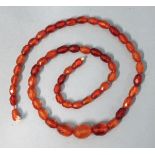 A string of graduated faceted amber beads, 17 x 11mm to 9 x 6mm, (a/f), 21g.