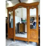 A large late-20th century Continental inlaid satinwood breakfront wardrobe, the arched cornice above