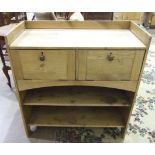 A stripped pine low unit, the rectangular top above two hinged drop-down doors and two-tier shelves,