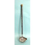 A late-George-III toddy ladle, the shaped bowl with embossed basket of flowers and foliate