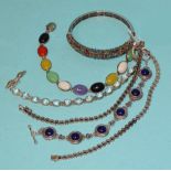 A silver hinged bangle claw-set multiple coloured stones, a pair of bracelets set round-cut