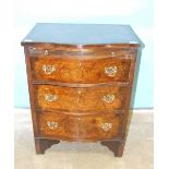 A reproduction walnut serpentine-fronted chest of three drawers, with slide, 60cm wide, 78.5cm high,