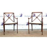 Pair of 19th century mahogany armchairs with X shaped backrests and line inlay on tapered supports.