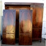 20th century mahogany triple wardrobe with single cupboard flanked by a two doors opening to