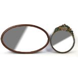 20th century mahogany oval wall mirror together with a small circular painted mirror with foliate