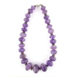 Amethyst graduated melon bead necklace, twenty seven carved oval amethyst beads, measuring from