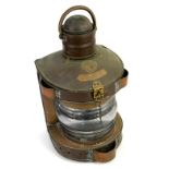 Large copper ships lantern, of rounded form with ribbed glass lens, with central applied plaque