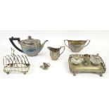 Small group of silver plate to include a three piece tea service, toast rack and desk set, bottle