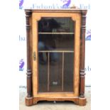 Early 20th century walnut music cabinet, the glazed door to reveal shelving with column support. 98H