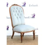 19th century mahogany button back nursing chair with fluted front supports.