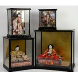 Traditional Japanese doll seated on a tatami mat, within a glass case w42cm x h43.5cm, another