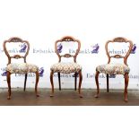 Set of three 19th century walnut dining chairs with shaped backrests on cabriole legs.