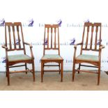 Set of three oak dining chairs with shaped backrest and tapered supports( 2+1) the base bearing a