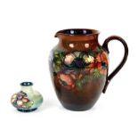 Moorcroft unusual brown flambe lustre glaze anemone jug, h20cm, and solifleur vase with orchid