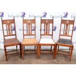 Four Arts and Crafts dining chairs, circa 1910, with pierced splat backs, H105cm