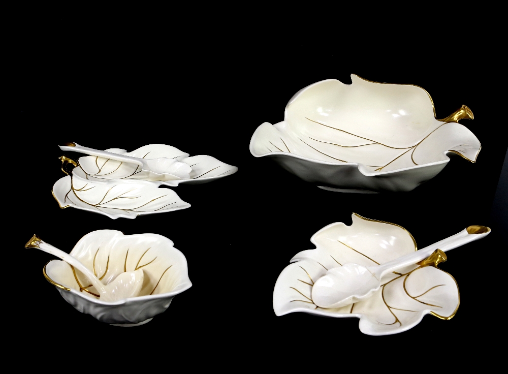 Four Carlton Ware leaf dishes with gilt on cream ground with three spoons