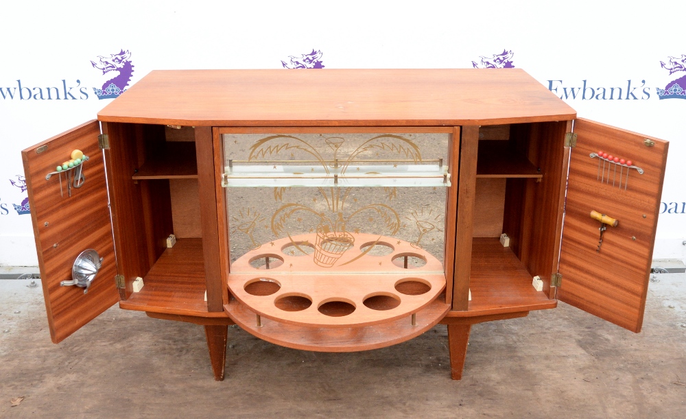 Mid century revolving cocktail cabinet with rotating central unit flanked by two cupboards with