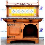 Art Nouveau oak washstand, the carved gallery with foliate decoration above a yellow tiled back,