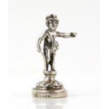 Novelty silver desk top letter seal in the form of a young man with a walking stick holding a piece