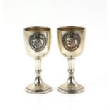 Pair of silver tot cups with Alsatian league motif with embossed Alsatian dog design,