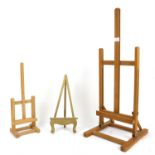 Nine beech wood table-top easels, four 45cm high, five 76cm high, and plate stands,