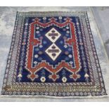 Persian Afshar rug with two central medallions on a blue ground within stylised floral bands,