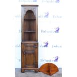 Oak corner cupboard with linenfold decoration to door, on bracket feet, together with a corner