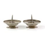Pair of Victorian silver salt dishes in the form of flower baskets, with floral embossed decoration,