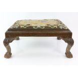 19th century carved mahogany framed foot stool, the drop with a wool work tapestry top depicting St