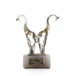 Sculpture of a pair of 800 grade silver Giraffes an on a stone base