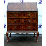 20th century reproduction walnut bureau, the fall front with fitted interior above three graduated