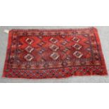 Persian red ground rug fragment, alternating stylised motifs within stylised floral borders,