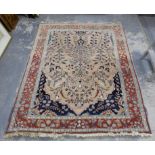 Persian rug with birds, scrolling foliage and a deer on a light pink ground within floral border