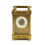 Late 19th century brass carriage timepiece, the case with pierced floral panels, bevelled glass