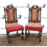 Pair of oak chairs, with vine leaf carving and floral embroidered seats, on baluster supports