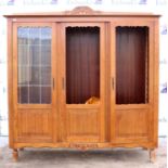 AMDENDED DESCRIPTION 20th century oak three door bookcase, one door with leaded glass (other two