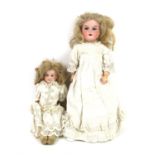 Two Armand Marseille AM 370 bisque headed dolls, one with stuffed leather legs, 34cm high,