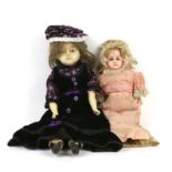 Wax over composition doll with cloth body and painted forelimbs, in velvet dress with bonnet,