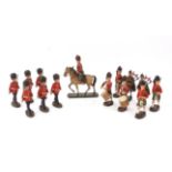 Fourteen elastolin figures comprising Gordon Highlanders and Grenadier Guards, (14),