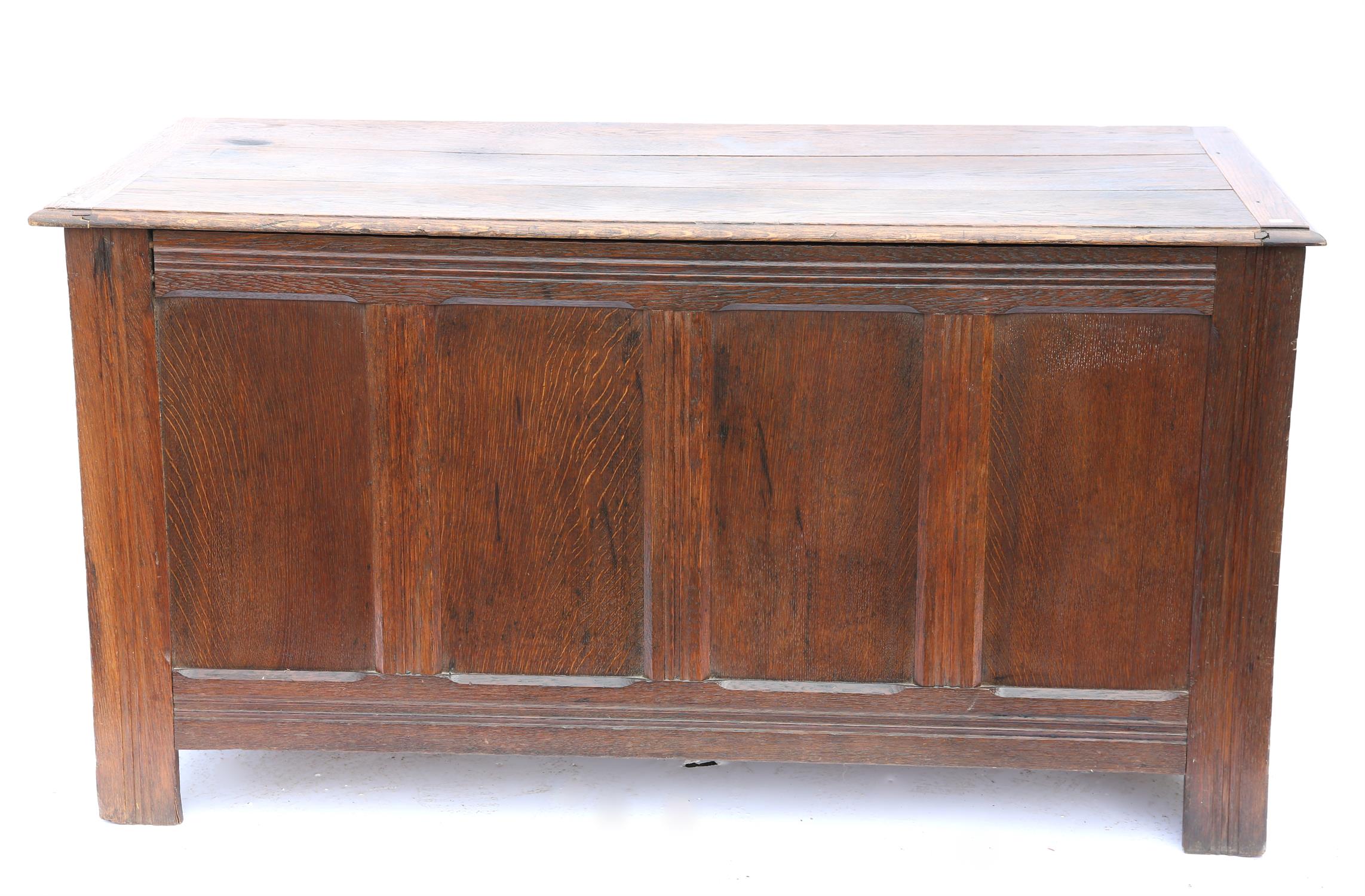 Large 19th century oak coffer, the plank top above panelled front on square legs,