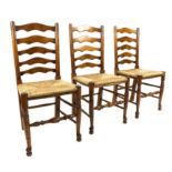 Set of six 19th century style oak ladder back chairs with rush seats, on turned legs joined by
