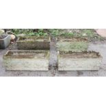 Four composite stone rectangular garden planters, relief decorated with scrolling flowers,