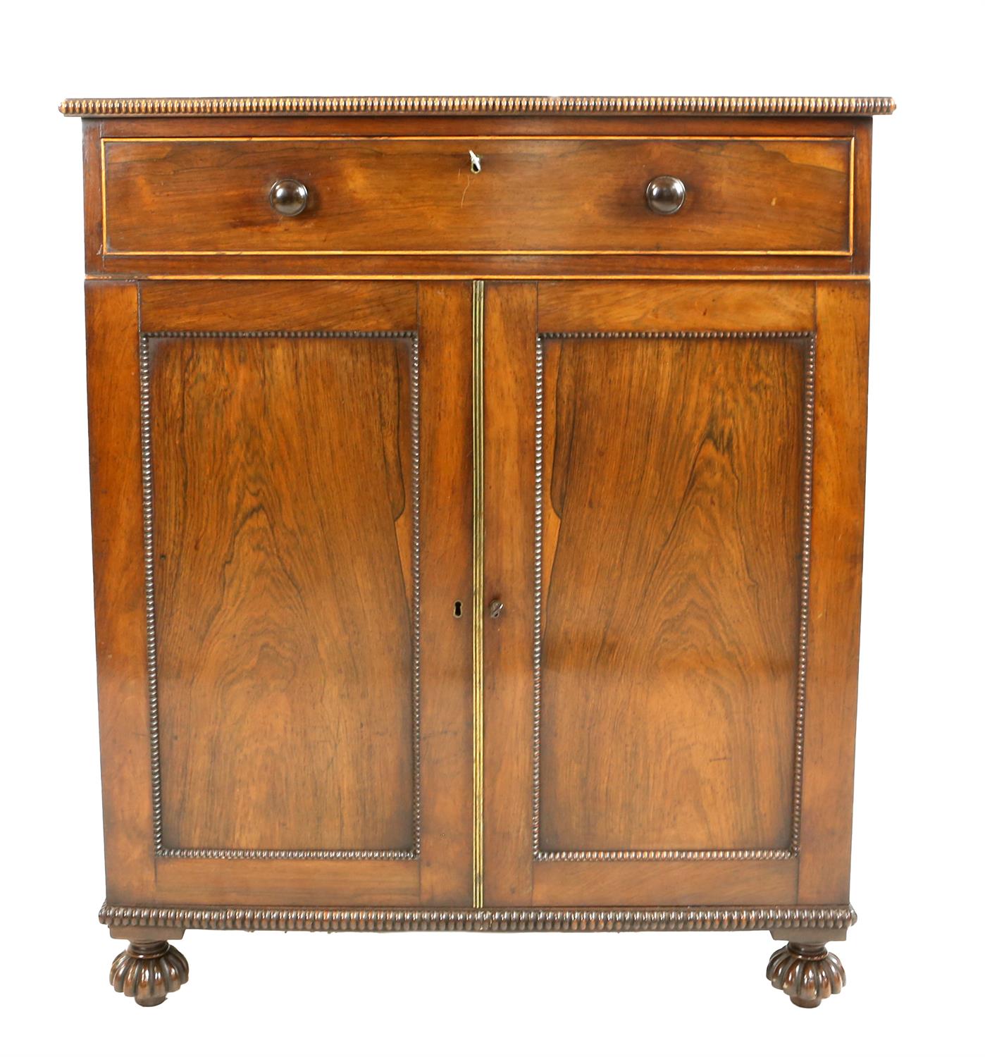 Pair of Regency rosewood cabinets, with gadrooned borders, each having a single drawer above two