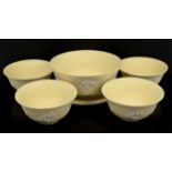 Wedgwood Primrose Yellow Jasperware footed bowl, 20cm diam, and four prunus pattern bowls,