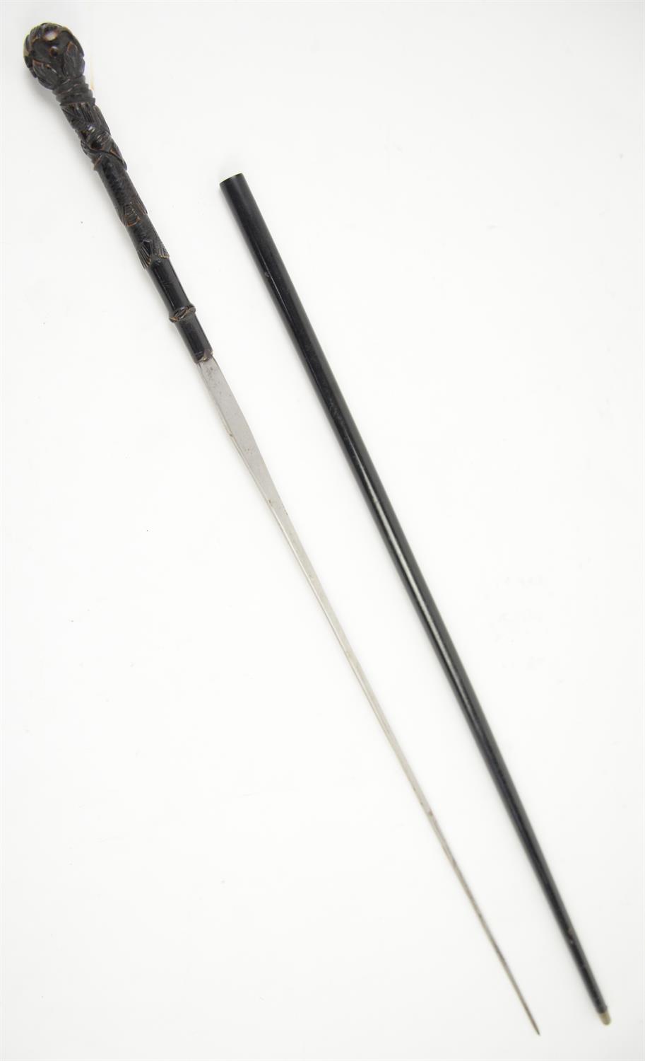 Early 20th century swordstick with carved ebonised handle in tubular black metal sheath, 94cm long, - Image 2 of 2