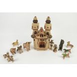 Collection of Peruvian pottery, to include a two-towered building, 36cm high, bull, 10.5cm high,