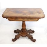 Regency rosewood fold over card table, with reeded and turned support on quatrefoil base with
