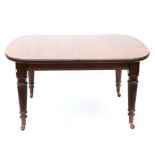 Late 19th century mahogany extending dining table, with reeded tapering legs on castors,